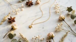 Gold star necklace flat lay on white marble — the ultimate star necklace guide 2026